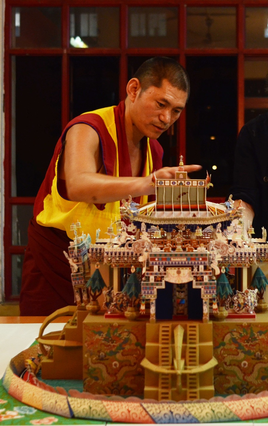 Master craftsman shaping a temple model